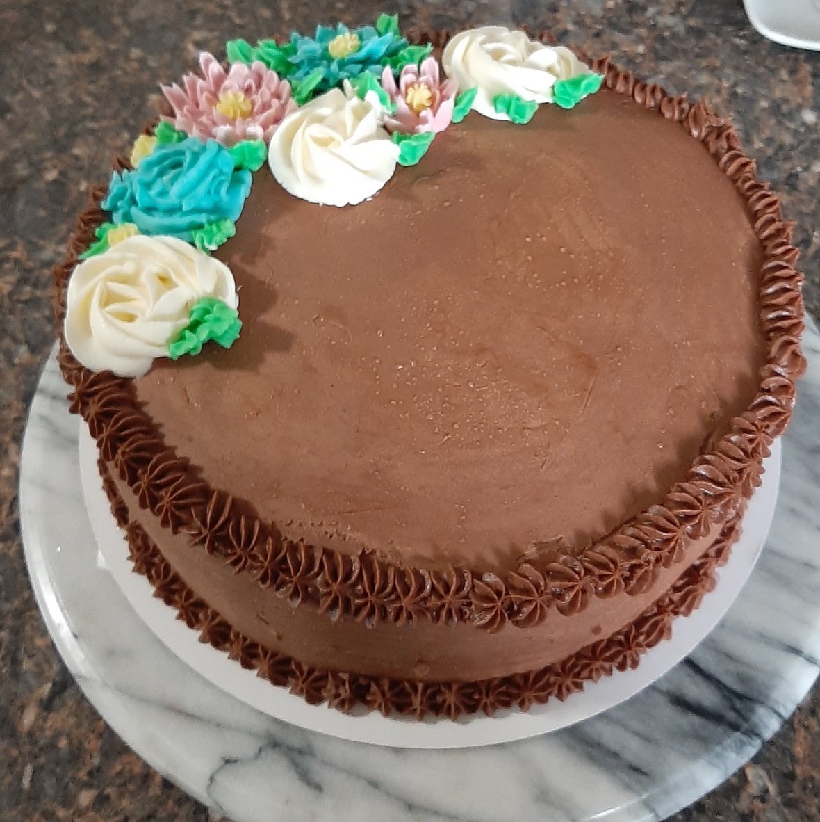 Regular Cake Chocolate Cake with flowers on it.